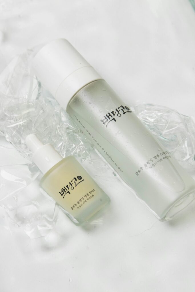 pexels photo 13946074 13946074 Elegant display of Korean skincare bottles on a white backdrop.